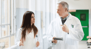 Two Physicians speaking in hospital hallway