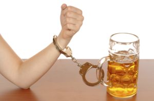 Hand Handcuffed to a beer