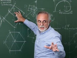 Teacher explaining something on a blackboard