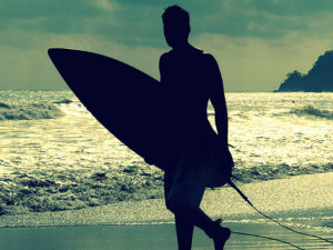 Surfer with ocean behind him